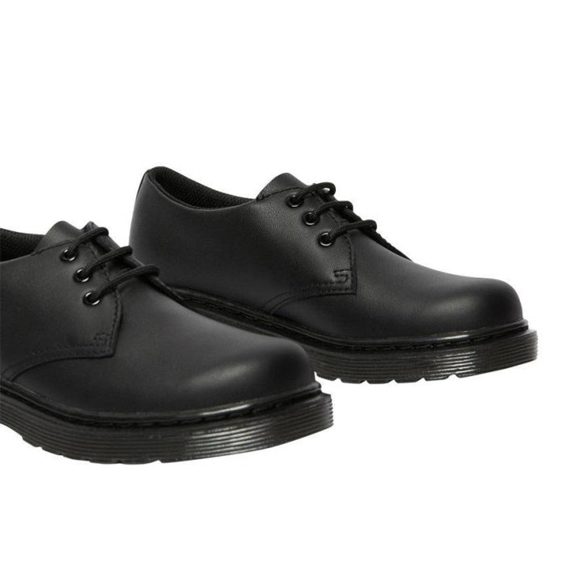A pair of Dr Martens kids 1461 Mono J Lace Up School Shoes in black, featuring smooth leather and thick rubber soles, displayed from a slightly angled side view on a white background., 20644, 20645, 190665364316, 190665364217, 20648, 190665364231, 20650, 