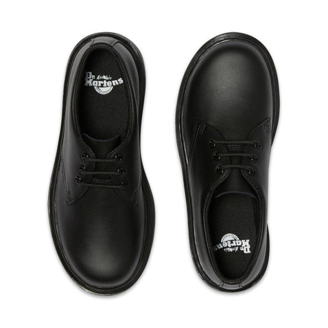 A pair of Dr Martens kids 1461 Mono J Lace Up School Shoes in black Softy T leather, viewed from above with visible brand logos on the insoles, are positioned parallel on a white background., 20644, 20645, 190665364316, 190665364217, 20648, 190665364231, 