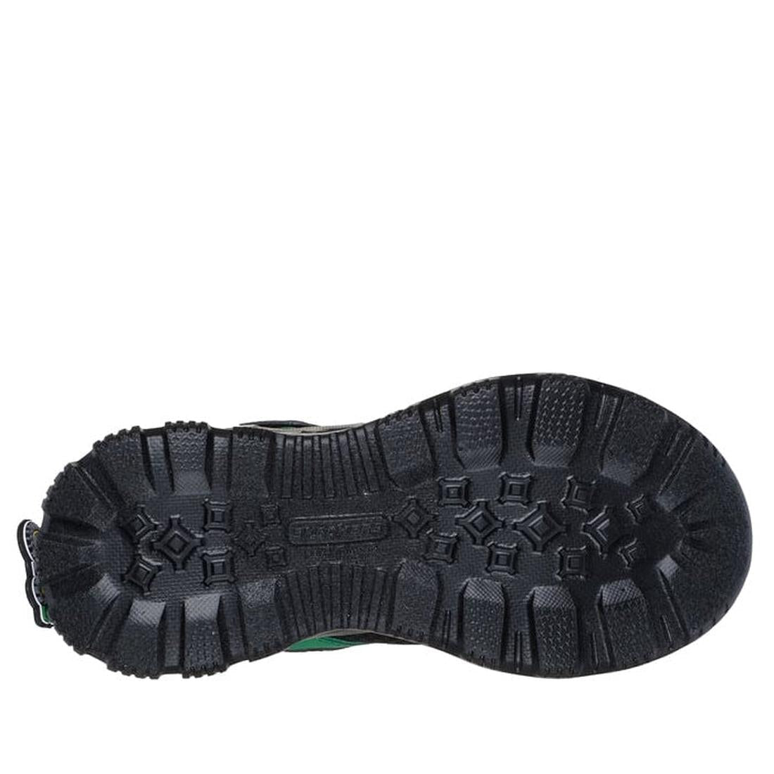 The image shows the bottom view of a black rugged boot sole with deep, textured treads for grip and durability. Like Skechers Boys Youths John Deere Sneakers Rugged Brights Light Ups Green, it features geometric patterns and thick grooves for stability., 