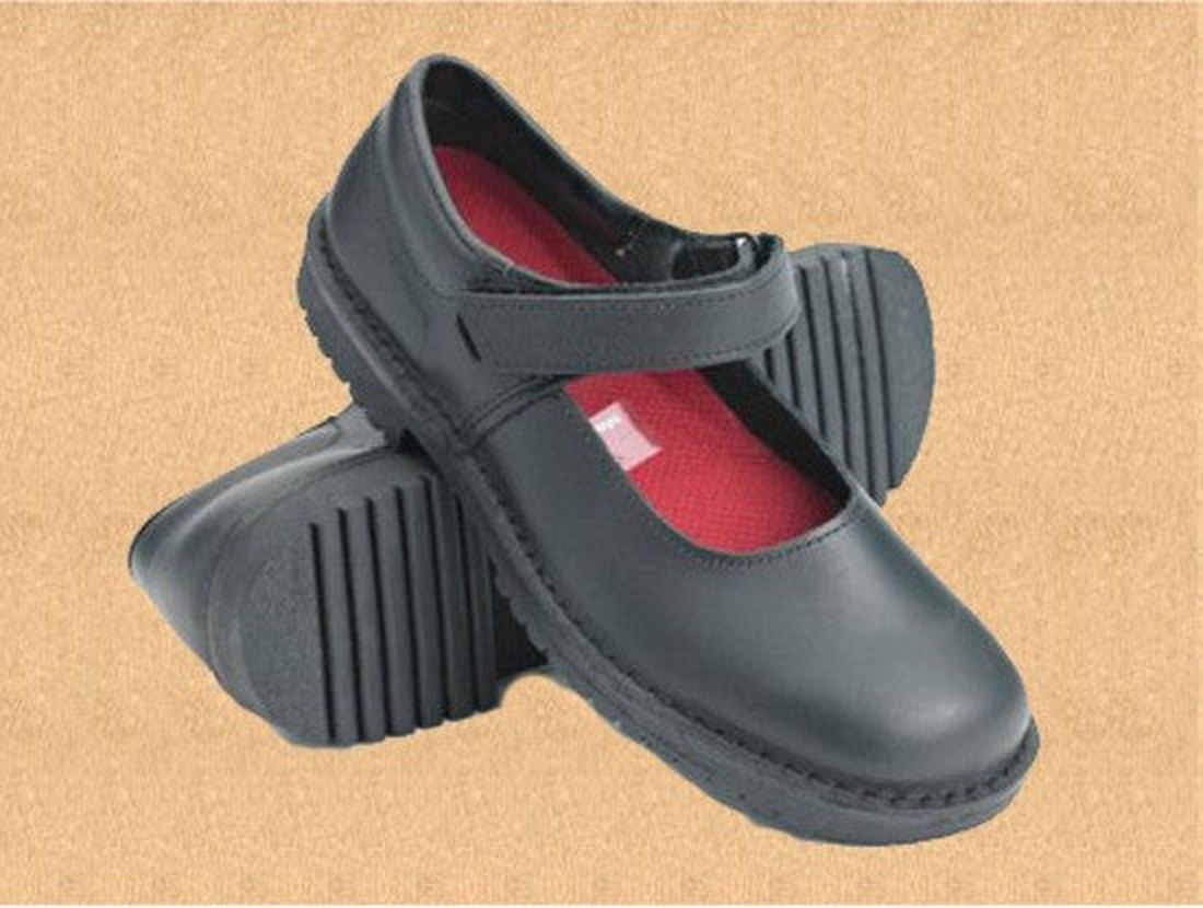 The Mckinlays Molly Girls School Shoe in black leather features a velcro strap, red insoles, and textured rubber soles, shown against a light brown background., 17203, 20780, 20781, 20782, 20783, 20784, 20785, 20786, 20787, 20788, 20789, MckinlaysMollyBla