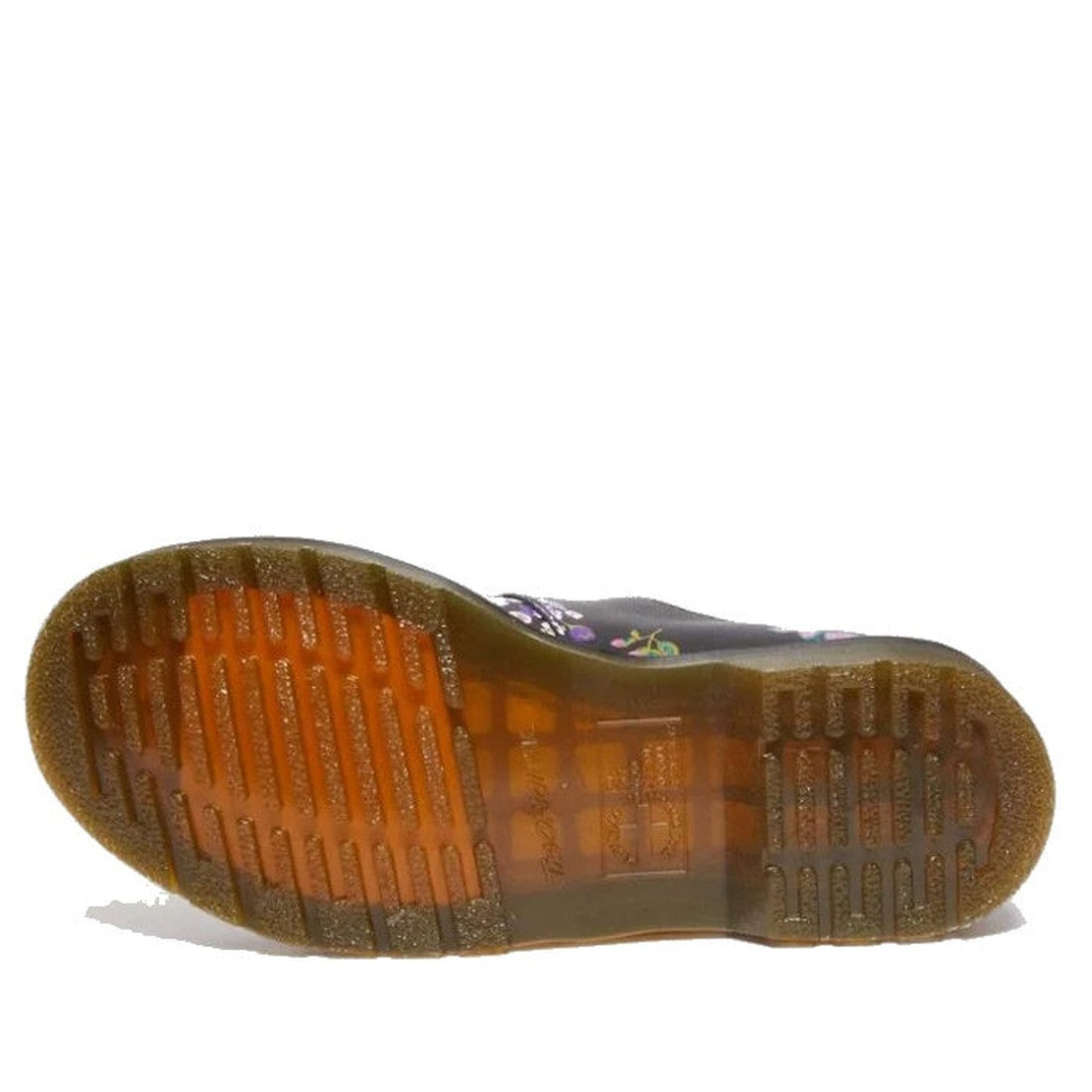 A close-up of the brown translucent sole with tread patterns and light reflections from the Dr Martens 8065 2 Strap Mary Jane Shoes Vintage Floral Black, with a glimpse of the shoe’s distinctive upper style., 190665573091, 190665573107, 190665573114, 1906