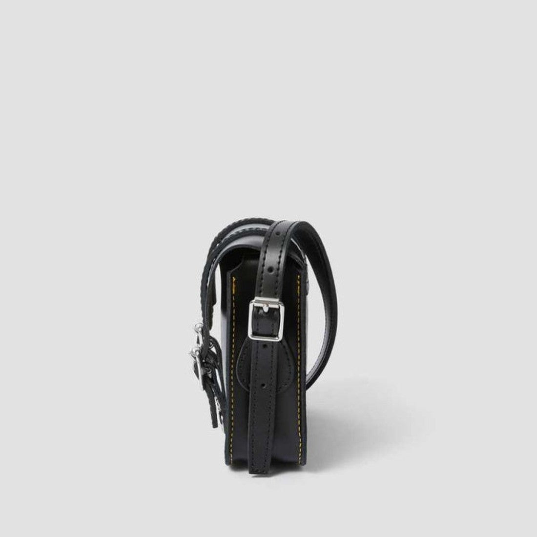 Dr Martens Leather Cross Body Satchel in classic black, with sturdy sole, secure silver buckle closure, and signature yellow stitching.  ksnz, 190665191974