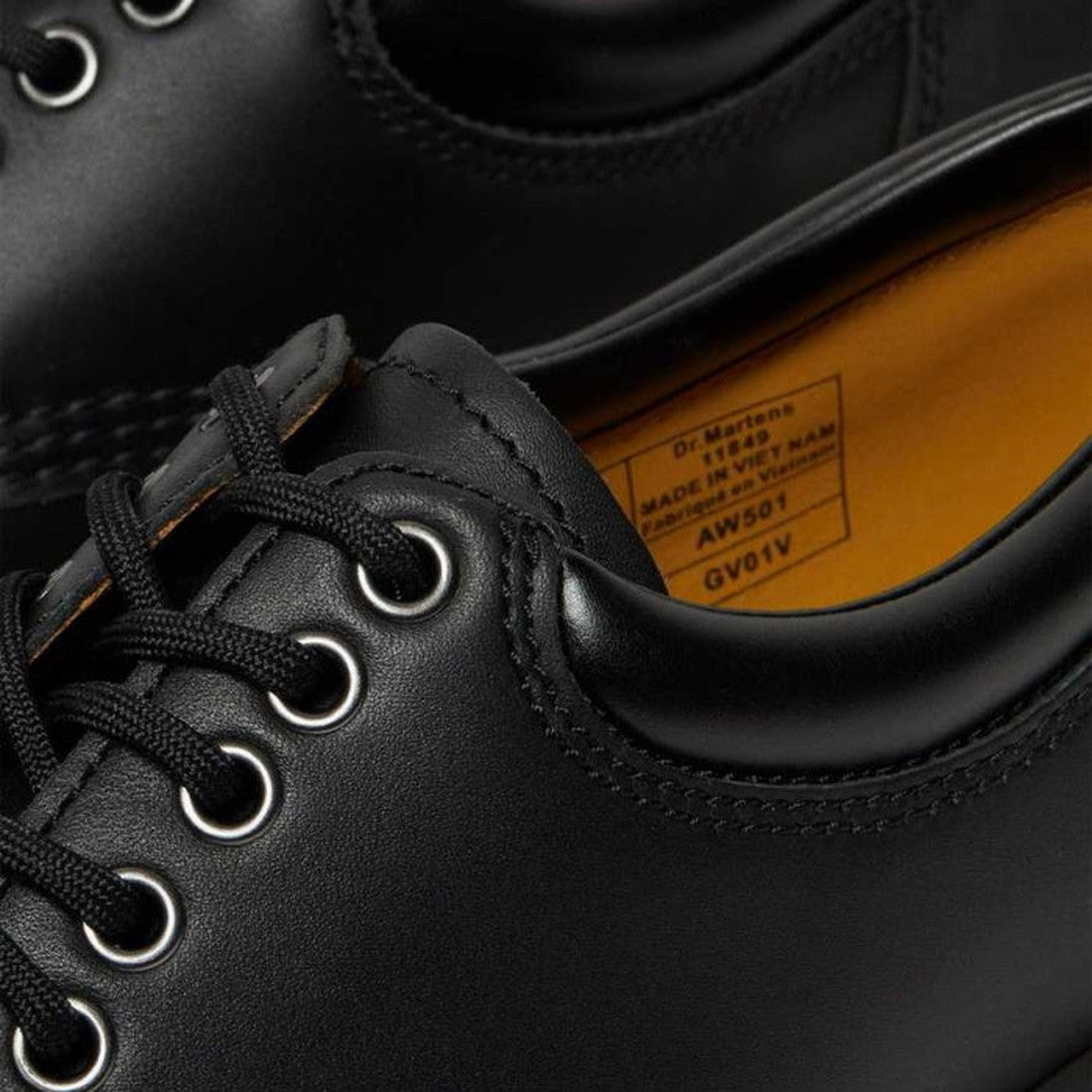 Close-up of Dr Martens - 8053 Nappa Black Padded Collar Shoes: unisex black nappa leather lace-ups with metal eyelets, yellow inner lining, Goodyear Welt construction, and visible label inside showing product details., 800090824704, 800090824728, 80009080