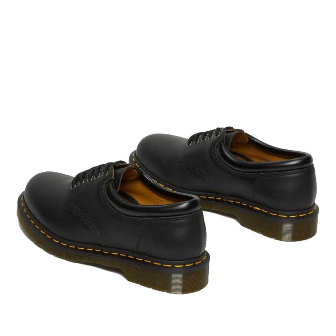 The Dr Martens 8053 Nappa Black Padded Collar Shoes are unisex lace-ups with black Nappa leather, thick brown rubber soles, and yellow stitching, shown against a white background., 800090824704, 800090824728, 800090801255, 800090801279, 800090801286, 8000