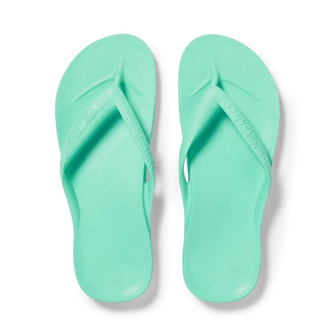 The Archies Footwear Arch Support Jandal Mint flip-flop in soft green has a comfy sole, roomy foot straps, and supportive arches.  ksnz