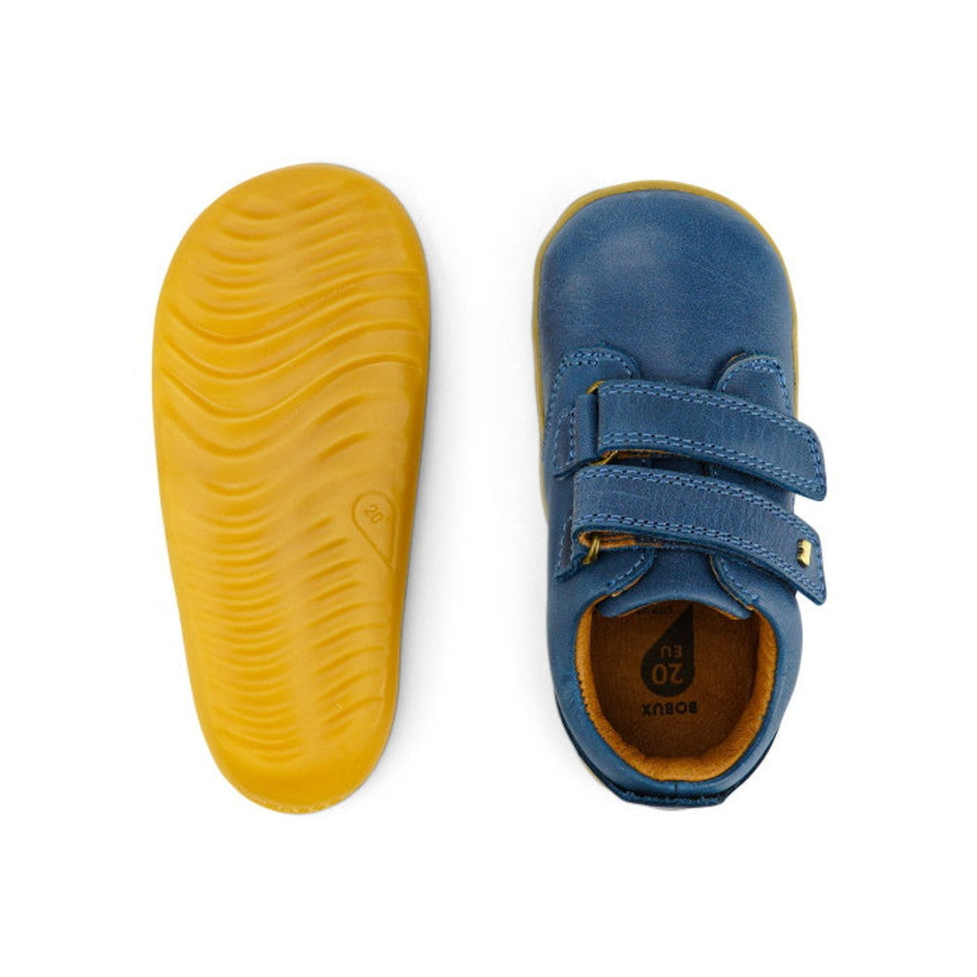 The Bobux Step Up Port Shoe Midnight Blue727718 is shown: one shoe features a yellow rubber sole with wavy grip, the other displays a blue leather upper with two velcro straps and a brown fabric lining., 9420068525566, 9420068525573, 9420068525559
