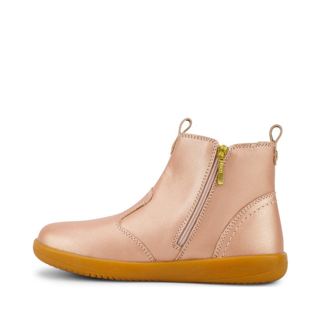 The Bobux Kid+ Jodphur Boot Rose Gold 830021 features a matte rose gold finish, gum-colored sole, side zipper, and front and back pull tabs—a sleek, minimal leather boot perfect for kids’ winter boot collections., 9420075719880, 9420075719897, 94200757199