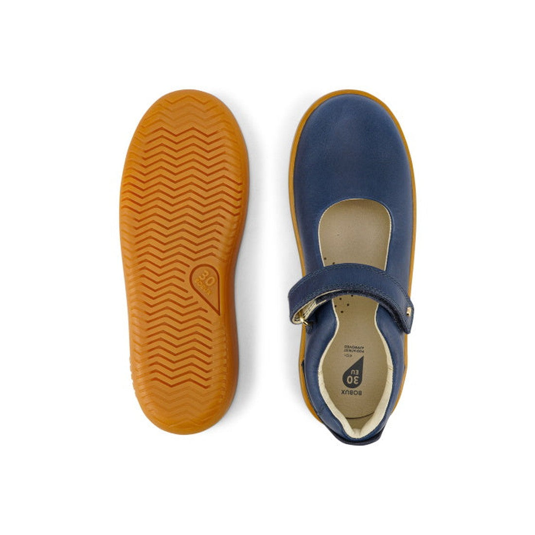 The Bobux Kid+ Delight Mary Jane Navy 831615Z features classic girls’ leather shoes with blue uppers, tan rubber soles, and a hook-and-loop strap. One shoe is shown from the top, the other from the bottom to display the tread pattern., 9420075721210, 9420