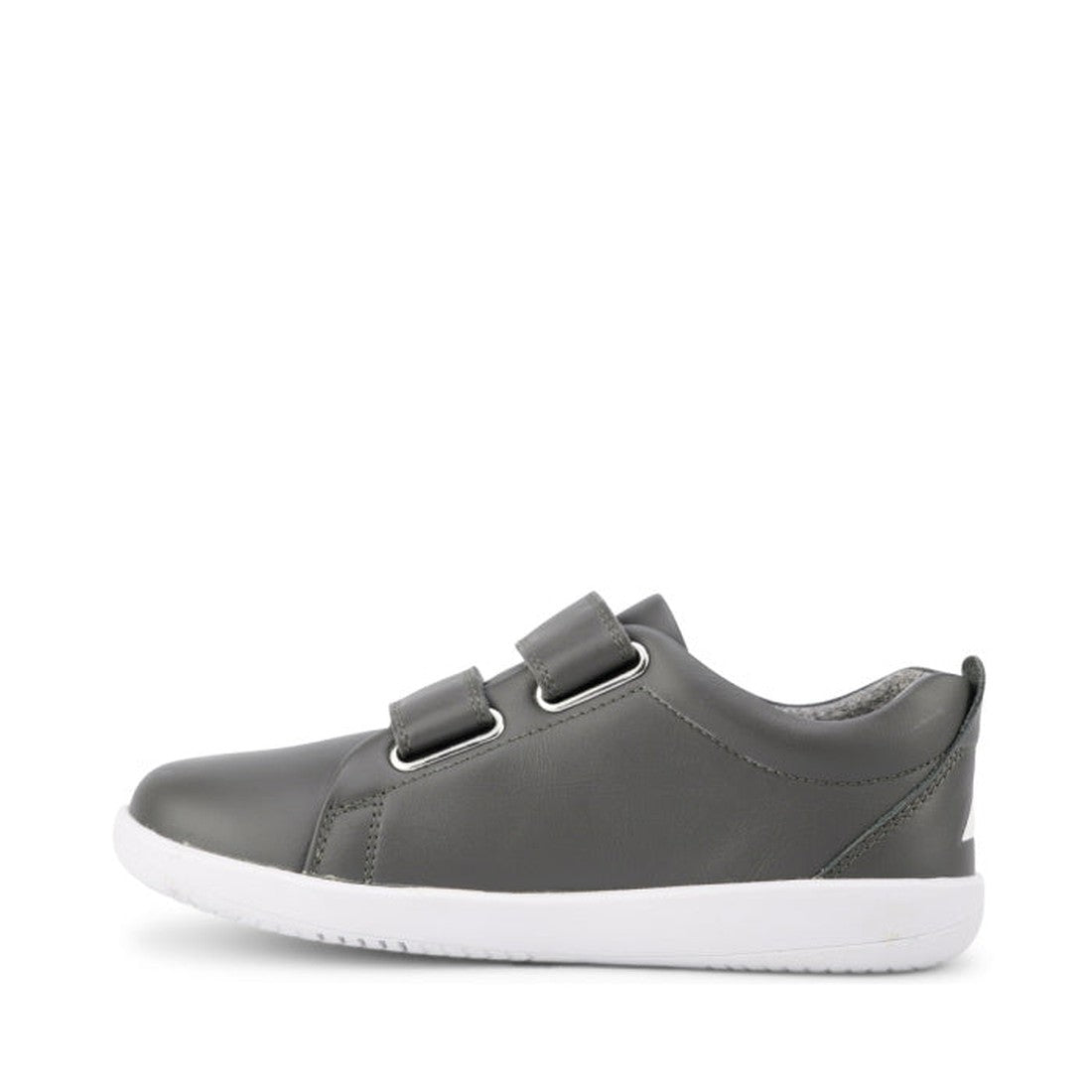 The Bobux Kids + Plus Grass Court Smoke Grey Velcro Trainers 832446 are gray kids' street shoes with two Velcro straps and a white rubber sole, shown from the side on a plain white background., 9420068518025, 9420068518032, 9420068518049, 9420068518056, 9