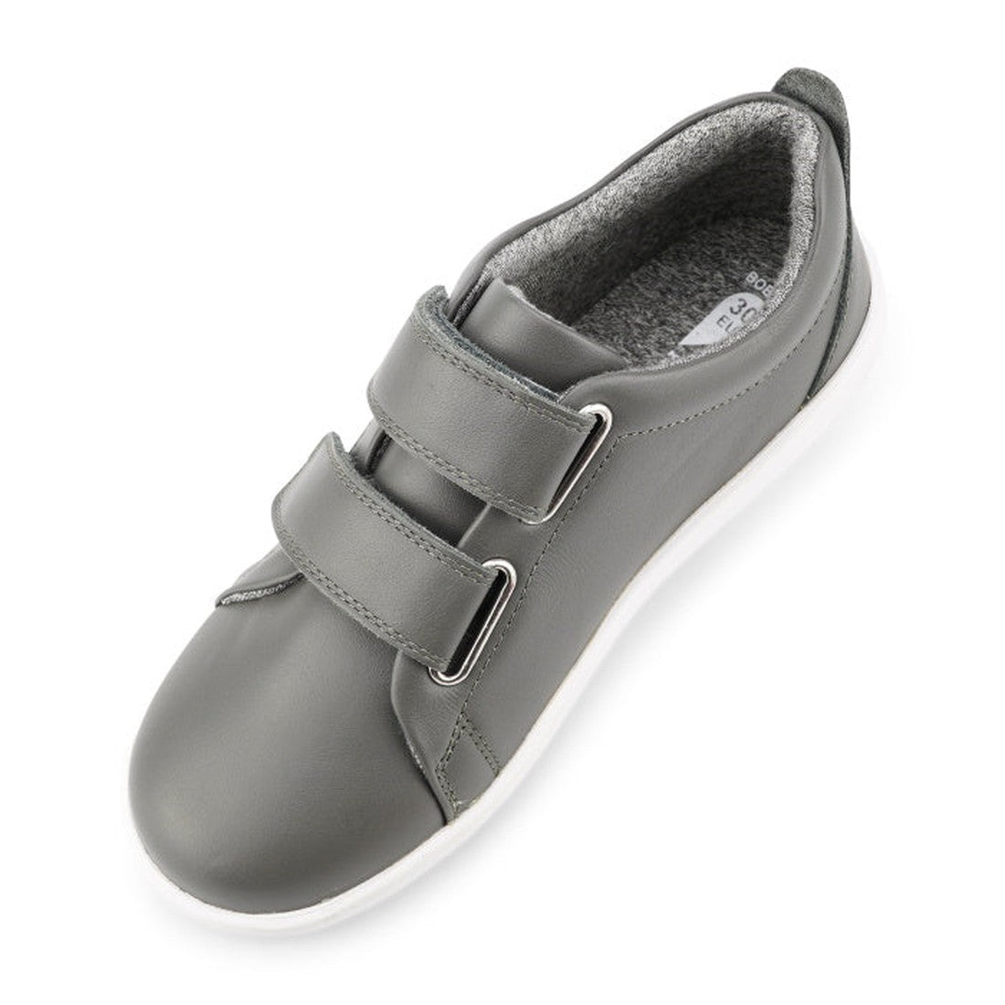 The Bobux Kids + Plus Grass Court Smoke Grey Velcro Trainers 832446 feature a gray leather upper, white sole, two adjustable Velcro straps, and soft padded lining—ideal everyday street shoes for kids' comfort., 9420068518025, 9420068518032, 9420068518049,