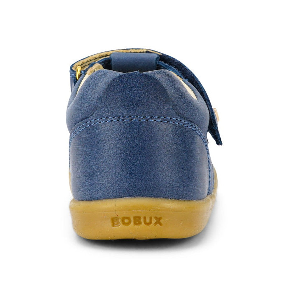 The Bobux IW Iwalk Louise Midnight Blue 633030 is a children's T Bar shoe with a blue leather upper and tan rubber sole, viewed from the back. The BOBUX name is embossed on the heel of the sole., 9420068521841, 9420068521858, 9420068521865, 9420068521872,