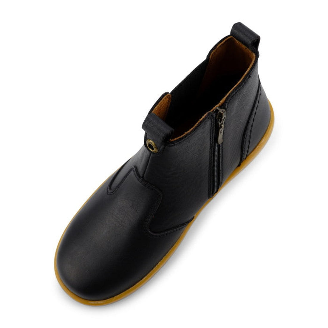 The Bobux Kid+ Jodphur Boot Black 830016Z is a unisex ankle boot in black leather with a tan rubber sole, brown lining, side zip closure, and front and back pull tabs, shown from an overhead angle., 9420075719811, 9420075719828, 9420075719835, 94200757198