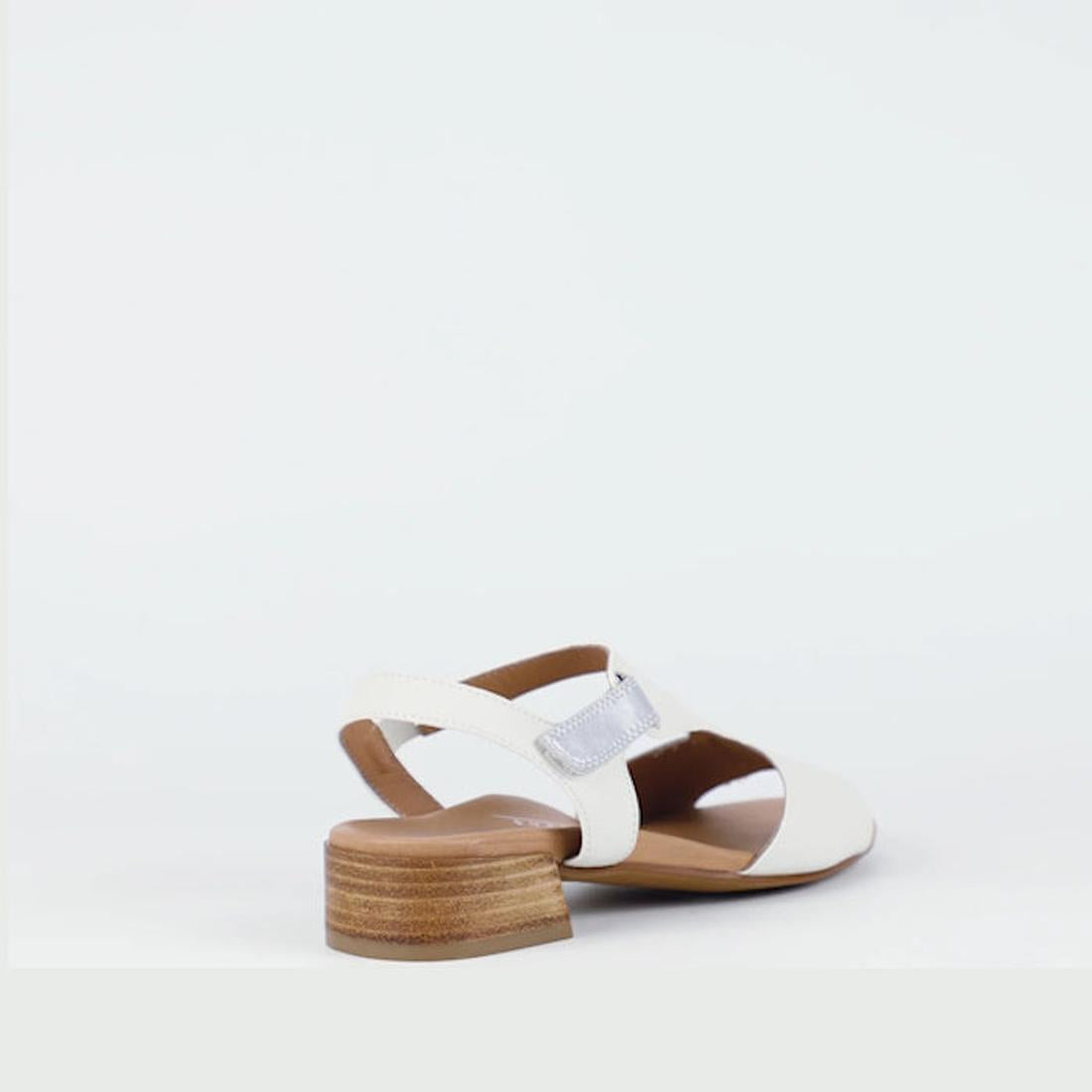 The Bay Lane Dune Womens Leather Low Heel Sandal in Ice White is shown from the back, highlighting its low wooden block heel, open toe, luxe support footbed, and chic white accent strap against a plain white background., 9357649063622, 9357649063639, 9357
