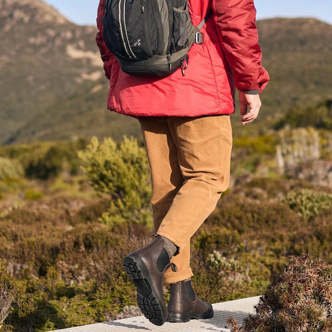 a picture showing a man on a hike walking away from the camera wearing 2340 bludstone boots. Lifting the right foot that shows the sole and the left foot on the ground showing the inner of the boot., 
9315891562553,
9315891562577,
9315891562591,
931589156
