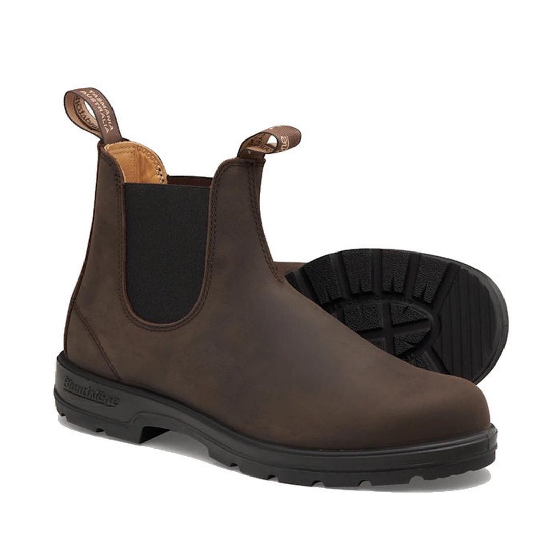 Blundstone 2340 Chelsea Pull On Boots in rich brown feature slip-on design crafted from premium water-resistant leather, with black elastic side panels, pull tabs, and a treaded XRD® Technology sole. One boot stands upright while the other lies on its sid