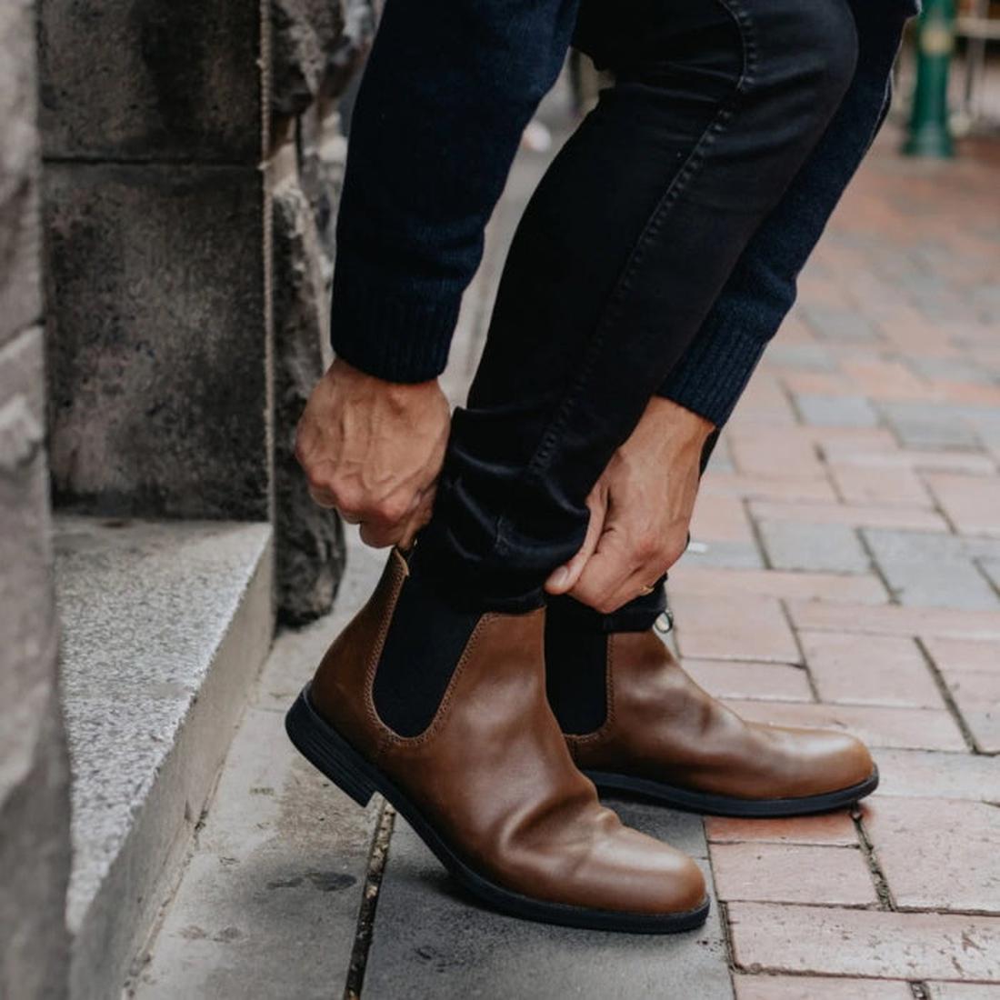 A man on a city street bending down and pulling on the blundstone 1900 dress boot in brown.
9315891500036,
9315891500050,
9315891500074,
9315891500098,, 10430, 10431, 10432, 10433, 9315891500036, 9315891500050, 9315891500074, 9315891500098