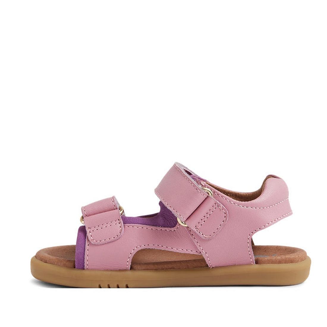 The Bobux IW Iwalk Strand Sandal Lilas Pink Open Toe features pink and purple hues, adjustable hook-and-loop straps, and a tan rubber sole, shown in side profile against a white background., 9420068556942, 9420068556959, 9420068556966, 9420068556973, 9420