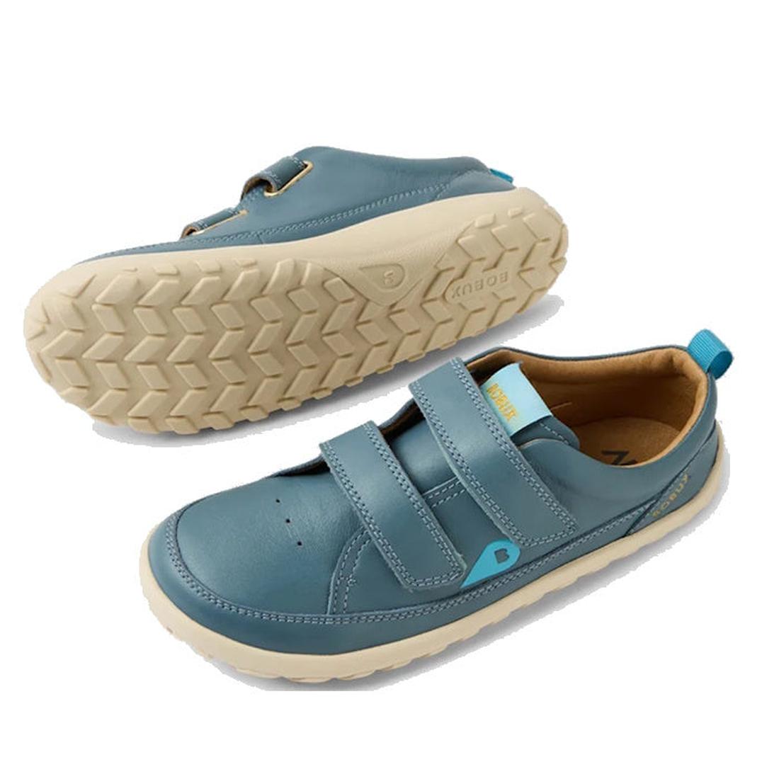 Bobux Kid+ Dawn Leather Sneaker in Stormy Weather Blue—cozy fit, beige soles, easy Velcro straps, and handy blue heel pull tab.  ksnz