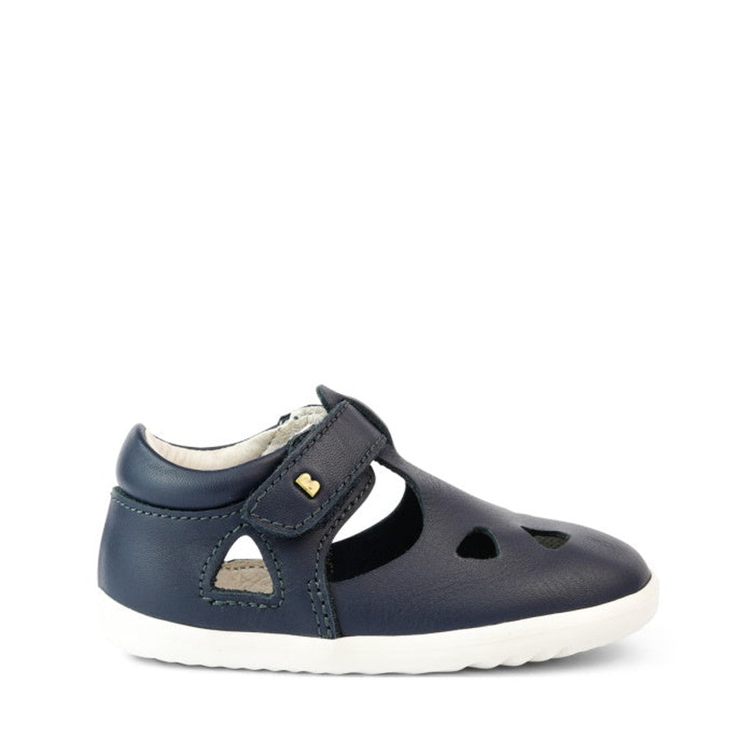 A Bobux Step Up Zap II Navy Closed Toe Sandal 732404 Quick Dry, made from quick-drying leather with a closed-toe, cut-out shapes, white sole, hook-and-loop strap and a small yellow heart, is shown against a plain white background., 9420068505476, 94200685