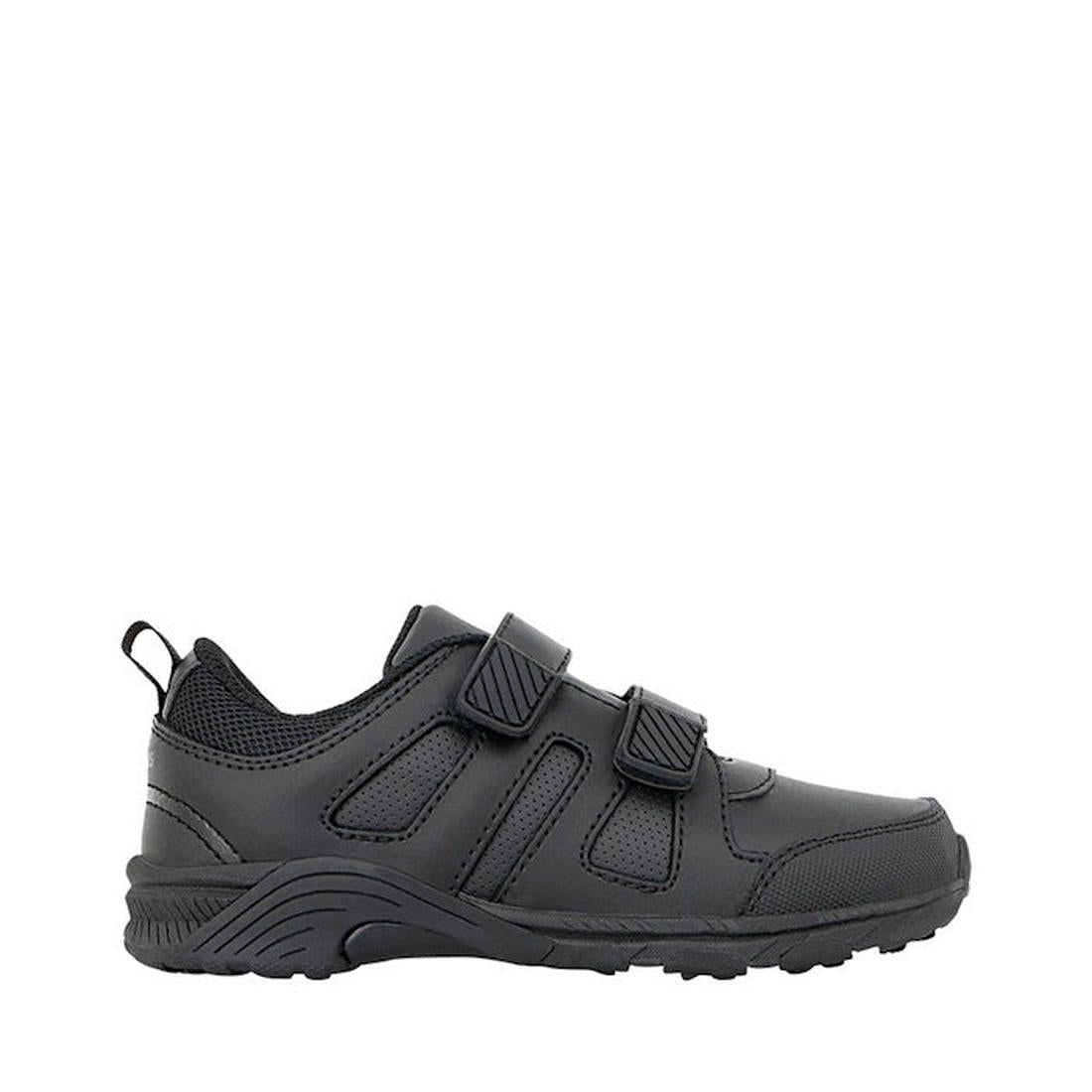 The Clarks Noah Black School Trainer is a black sports shoe with a textured sole, mesh accents, and two self-fastening straps. It features a memory foam innersole for comfort and is shown in side profile against a white background.