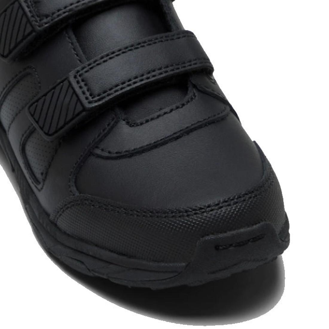 Close-up of the Clarks Noah Black School Trainer featuring self-fastening straps, textured side and toe, a patterned sole, and a comfortable memory foam innersole, displayed against a white background., 9336078911681, 9336078300249, 9336078300263, 9336078