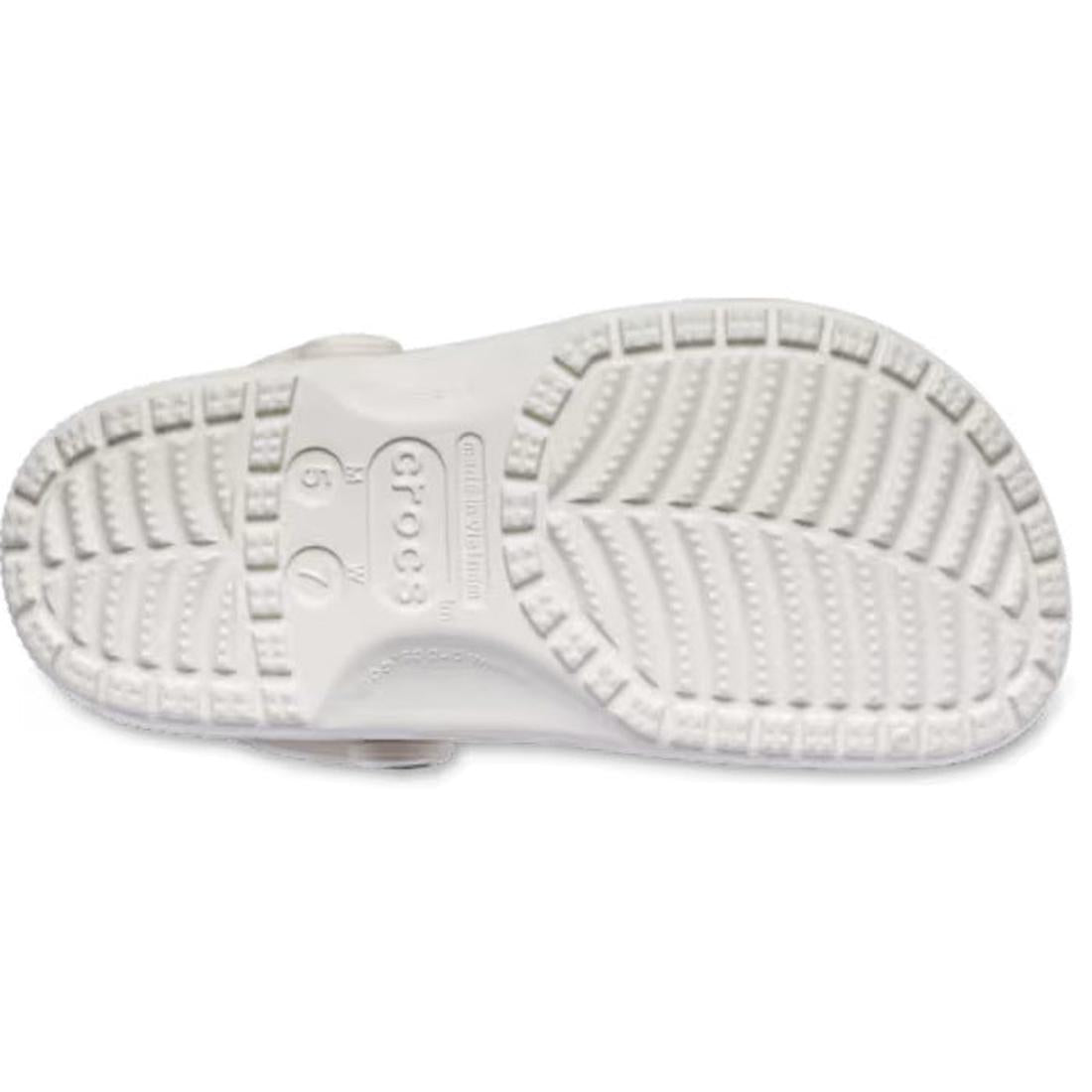 The Crocs Adults Classic Animal Clog Almond Tint Leopard is shown from the bottom, featuring a textured sole with deep grooves, circular patterns, and the Crocs logo embossed in the center for supportive comfort., 51497, 198445344978, 198445344961, 198445