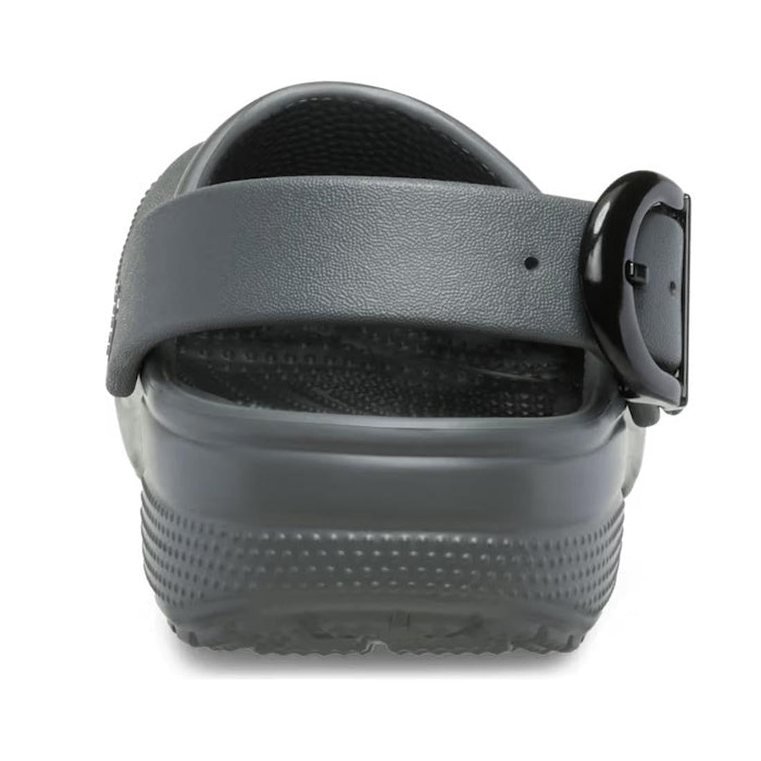 A close-up rear view of the Crocs Adults Classic Enamel Buckle Clog in Carbon Grey, featuring an adjustable backstrap with a black buckle and showcasing its textured sole and heel area., 51696, 198445415715, 198445415722, 198445415739, 51700, 51701, 51696, 198445415746