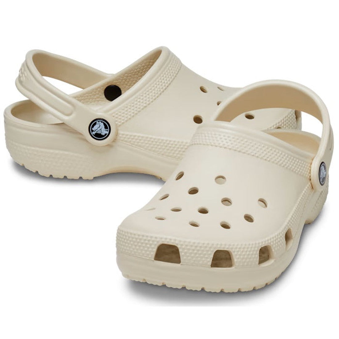 Crocs Kids Classic Clog in Bone—youth sizes, comfy slip-on shoes with airy holes, sturdy sole, and secure heel strap on white.  ksnz