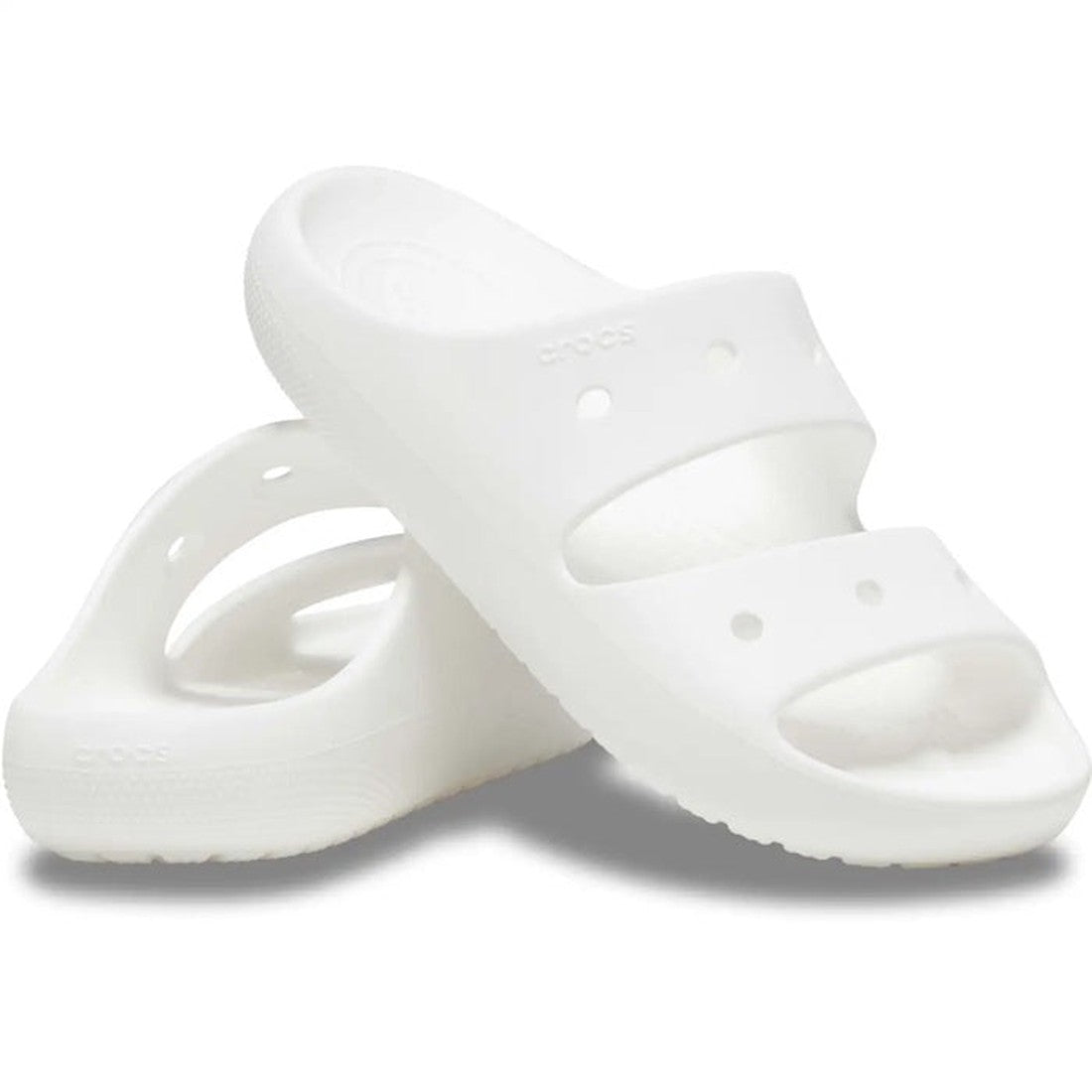 Crocs Classic Sandal V2 White for adults, with sturdy thick soles and two comfy wide straps. One sandal upright, one leaning close.  ksnz