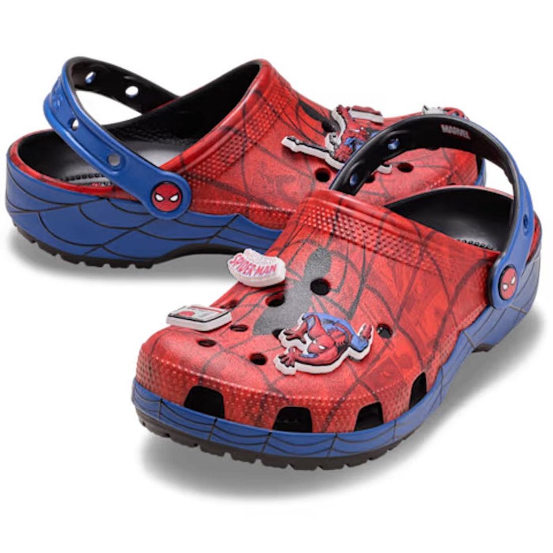 The Crocs Kids Spider-Man Web Classic Clog in red for junior youths features a Spider-Man design with web patterns, character face accents, and fun Jibbitz Charms on top and strap for a playful twist on the classic clog.