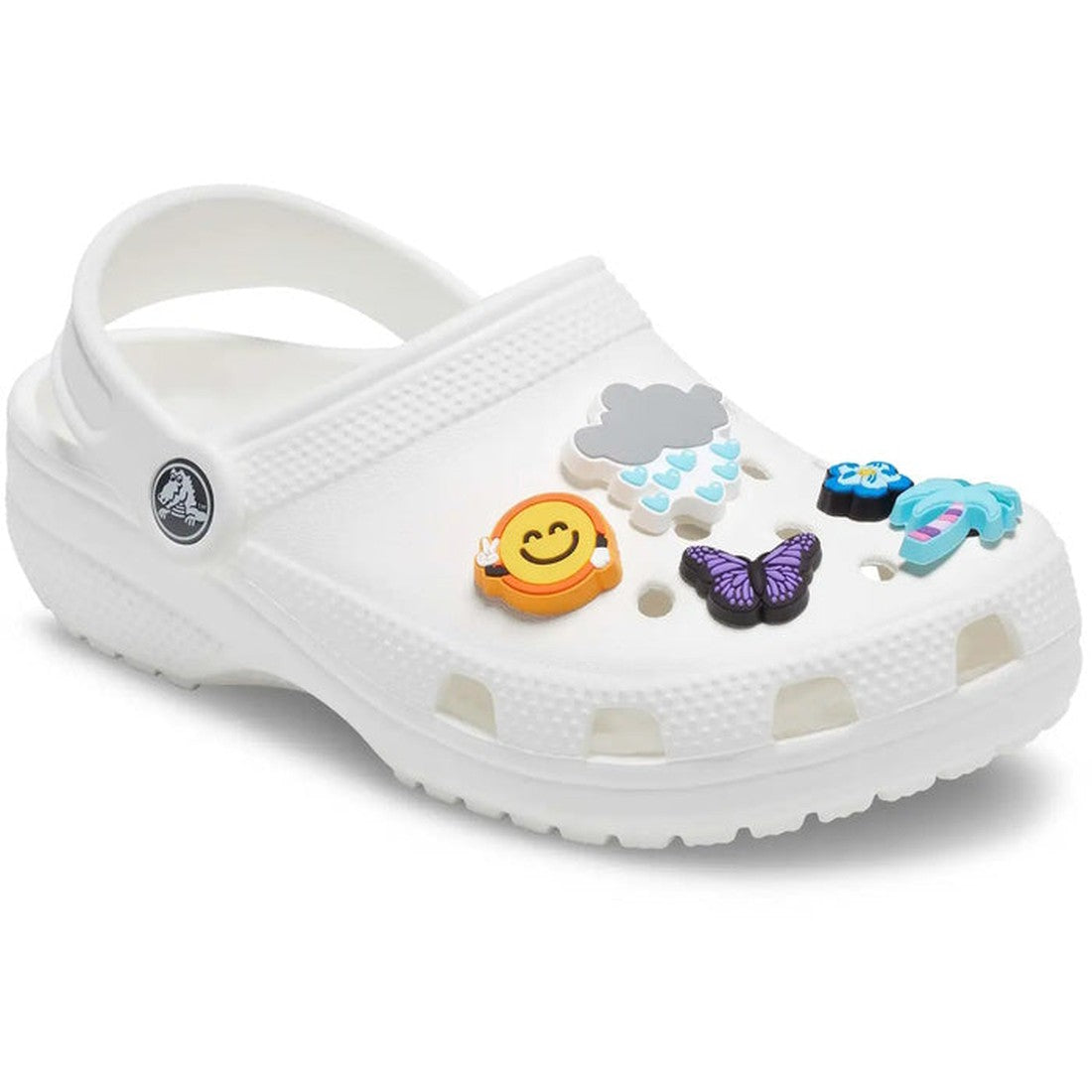 A white clog-style shoe featuring the Crocs Jibbitz 5 Pack - Chill Summer with charms like a gray rain cloud, yellow smiley face, purple butterfly, blue flower, and blue turtle attached on top., 196265284108