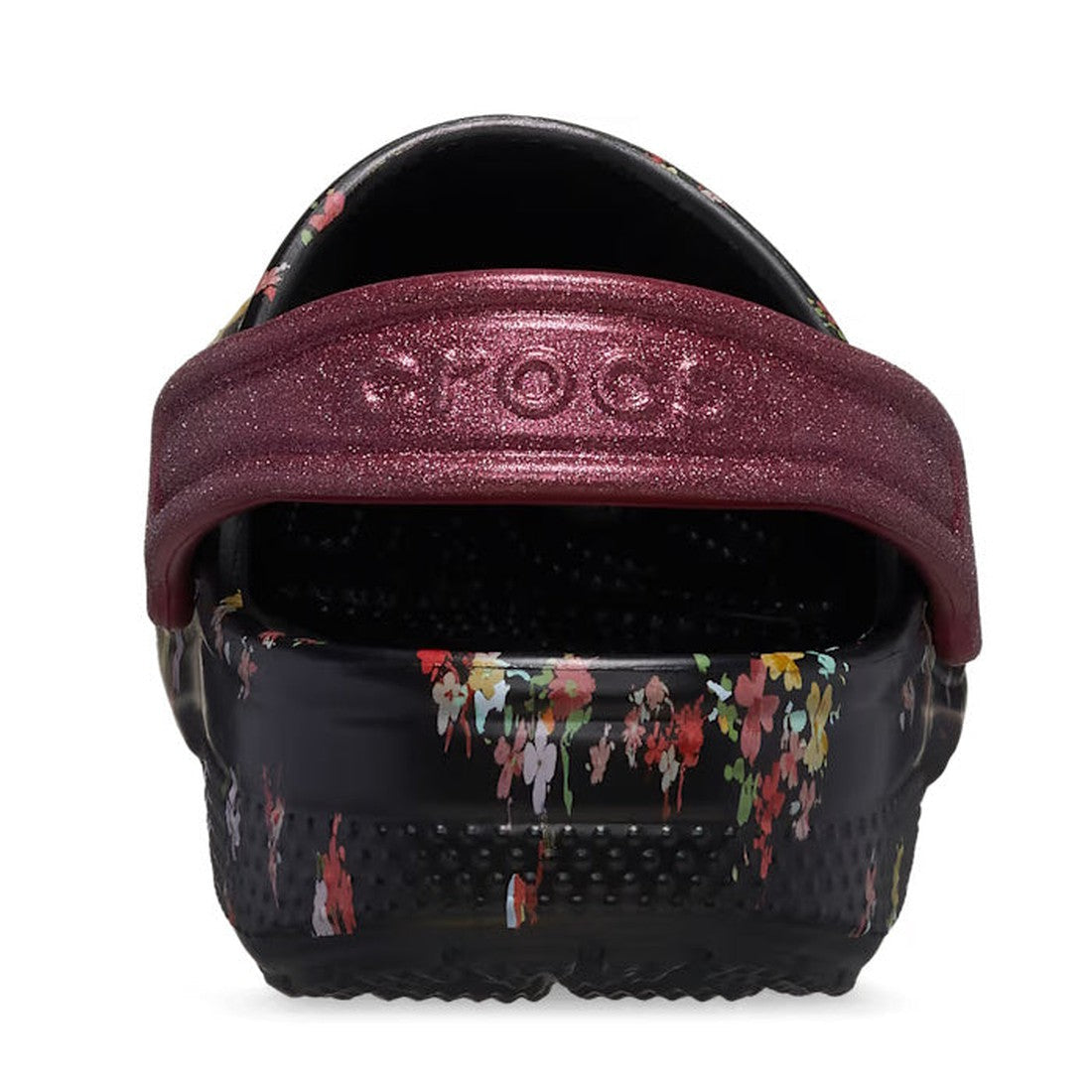 The Crocs Kids - Youths Classic Clog K Ditsy Floral Black Multi Sandal showcases a ditsy floral pattern and sparkly maroon heel strap embossed with the brand name, blending classic Crocs comfort with playful style., 196265775637, 196265775644, 19626577565