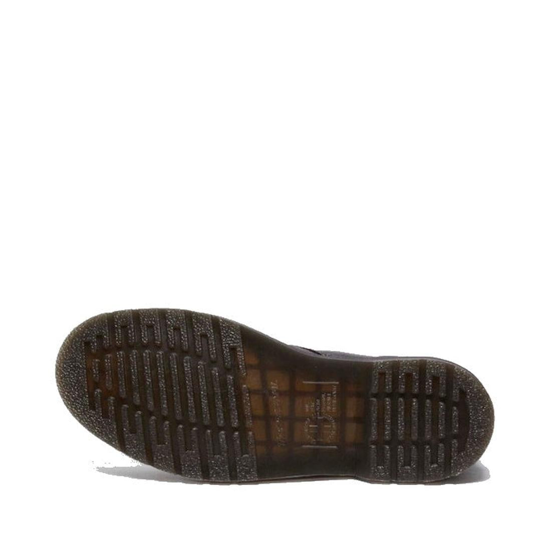 The image shows the bottom view of the Dr. Martens 101 UB Black Ambassador 6 Eye Leather Boot, highlighting its translucent brown rubber sole with ridged tread for grip against a plain white background., 190665693683, 190665693690, 190665693706, 190665693