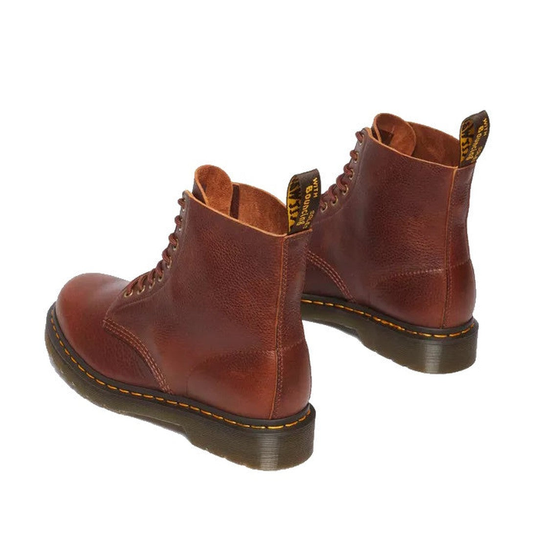 A rear, heel view of a pair od Dr Martens Cashew tan 1460 Pascal boots showing detailed re-enforcing up the back of the leg, side view of the boots with yellow stitching around the sole., 190665662757,
190665662764,
190665662788,
190665662795,