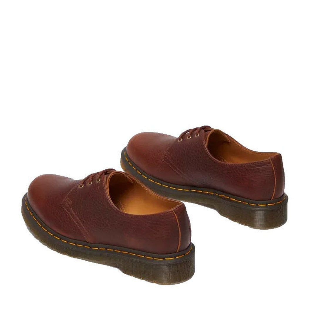 Dr Martens 1461 Shoes in Cashew Tan Ambassador leather feature textured uppers, yellow stitching on the sole, and thick translucent AirWair soles with a 3-eye lace-up Oxford design.