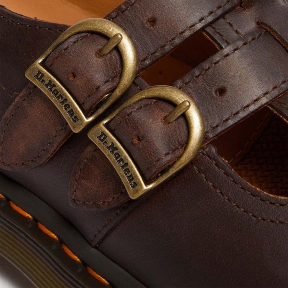 Close-up of the Dr Martens 8065 2 Strap Mary Jane Shoe in Crazy Horse Brown, featuring dual brass buckles with “Dr. Martens,” double stitching, and signature yellow welt stitching near the sole., 190665588941, 190665588958, 190665588965, 190665588972, 131