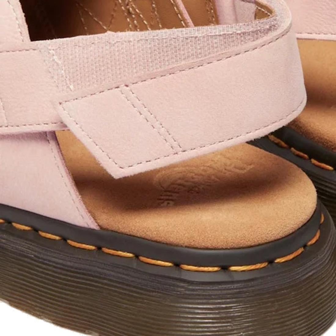 Close-up of the heel velcro strap of Dr Martens Jorge Mule pink sandal with a brown sole and yellow stitching around the sole on a white background.,
190665705478,
190665705485,
190665705492,
190665705515,
190665705522,, 45123, 190665705478, 190665705485,