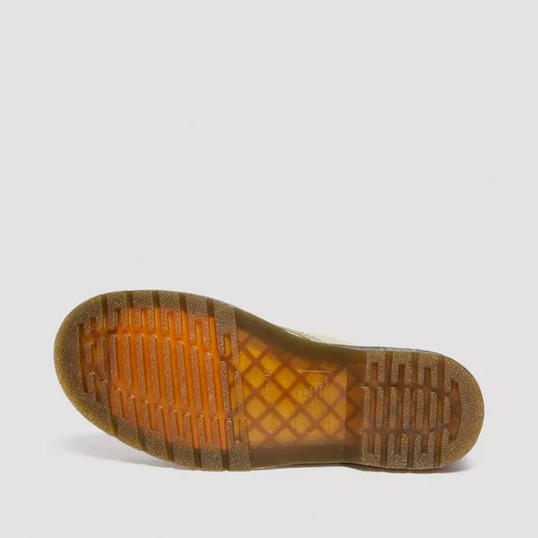 The image shows the sole of a Dr Martens 1460 Smooth Pale Olive 8 up Leather Boot, featuring a translucent amber rubber bottom with a grid and stripe tread pattern, set against a plain light gray background., 190665531824, 190665531831, 190665531848, 1906