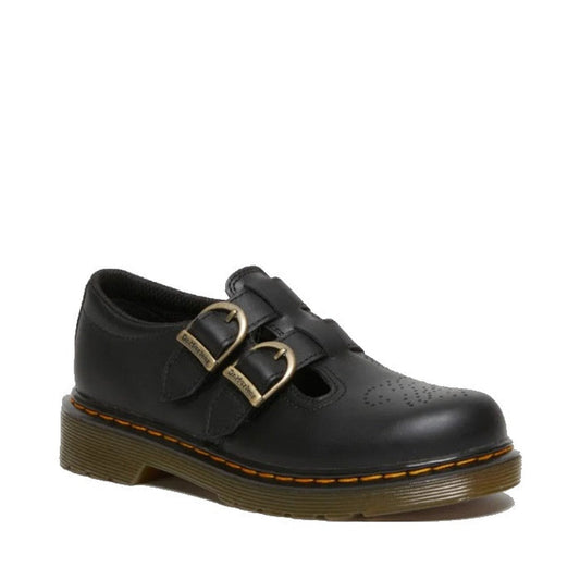 The Dr Martens Kids 8065 J Black Softy T Mary Jane Leather Shoe features two brass buckles, perforated toe detailing, a thick grooved air-cushioned sole, and visible yellow stitching for a classic, sturdy look.