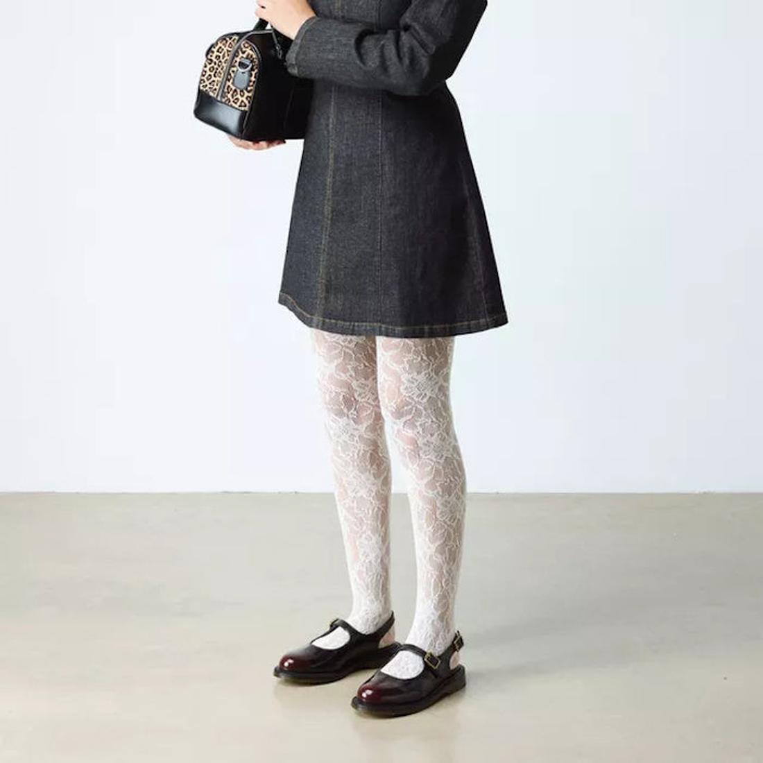 A person in a dark dress and white lace-patterned tights stands on a light floor, holding a small leopard-print handbag. They wear Dr. Martens Madaline Cherry Red Arcadia Women's Slingback Mary Jane Shoes; their face is not visible., 52343, 190665775976, 