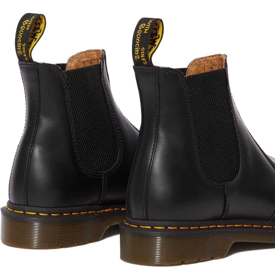 Close-up of the Dr Martens 2976 YS Chelsea Boot Smooth Leather Black: features yellow stitching, black elastic side panels, and branded yellow heel pull tabs—showcasing the classic slip-on Chelsea boot style., 883985986695, 883985986701, 883985986718, 883