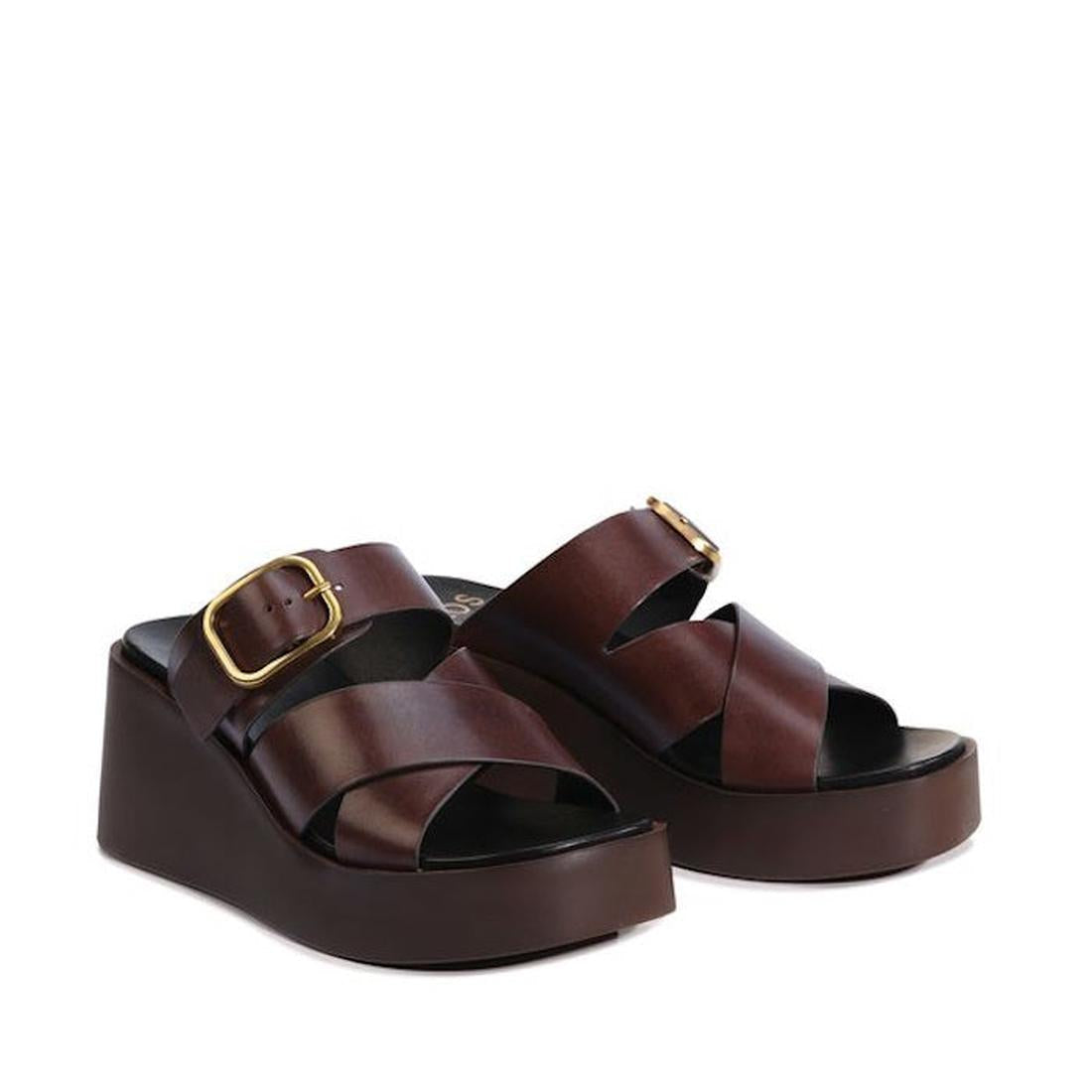 The EOS Aris Womens Chestnut Brown Leather Wedge Slide features premium calf leather, crisscross straps, gold buckles, and thick dark brown platform soles for stylish comfort and lasting durability., 48005, 9321191293646, 9321191293653, 9321191293660, 932