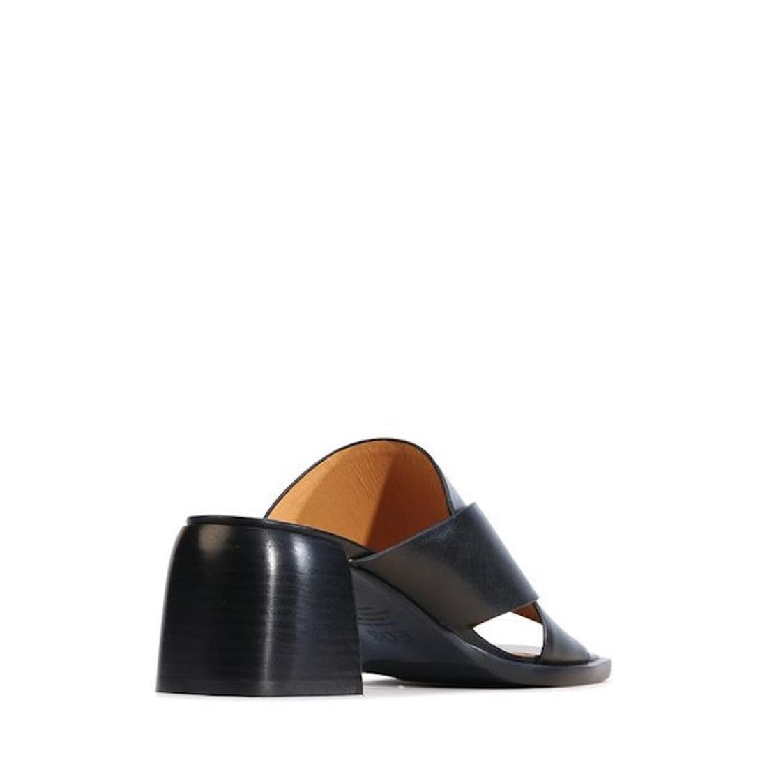 The EOS Iso Black Leather Heeled Sandal is a black, open-toe mule featuring a wide cashmere leather strap and a chunky mid-height block heel, shown from the side and slightly behind on a white background., 9321191306735, 9321191306742, 9321191306759, 9321