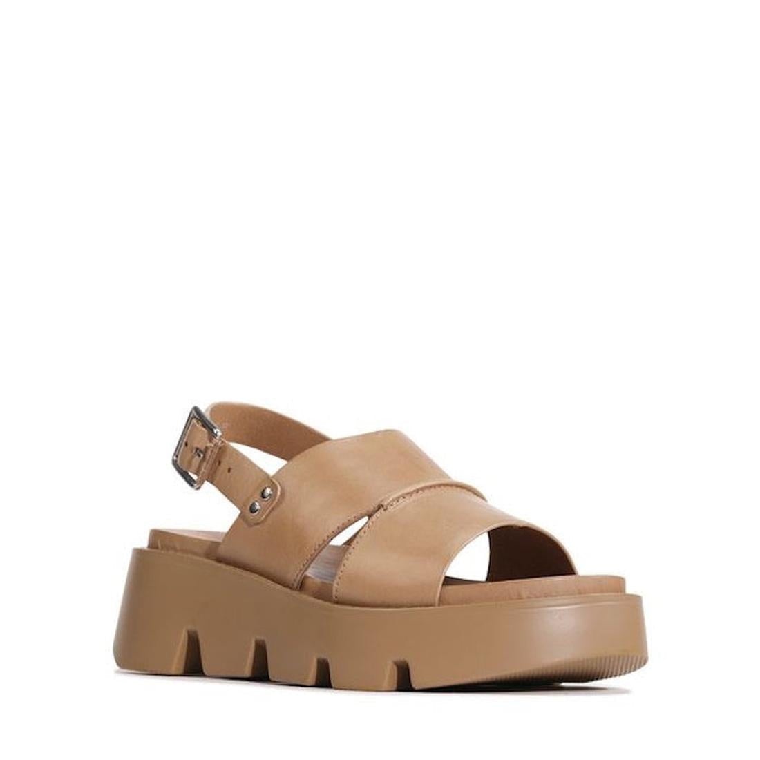 The EOS Kaily Womens Desert Leather Chunky Dressy Sandal features tan leather, thick crisscross straps, an adjustable side buckle, open toe, slingback design, and a chunky ridged sole for stylish comfort.