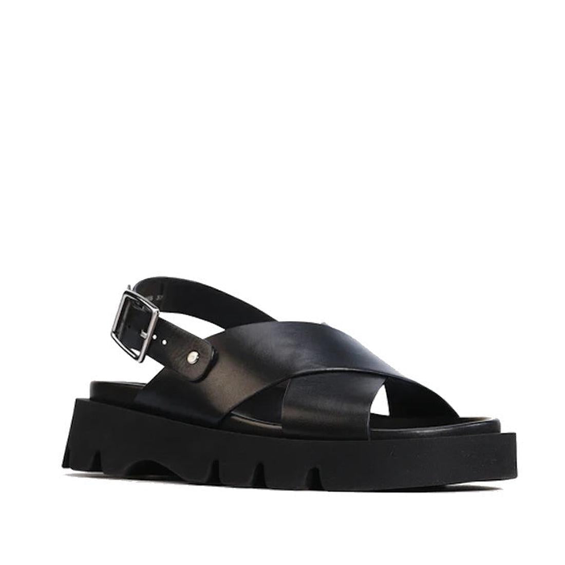 The EOS Monnis Black Womens Leather Sandal features hand-burnished black leather, chunky ridged sole, wide crisscross straps, open toe, and an ankle strap with silver buckle, shown on a white background.