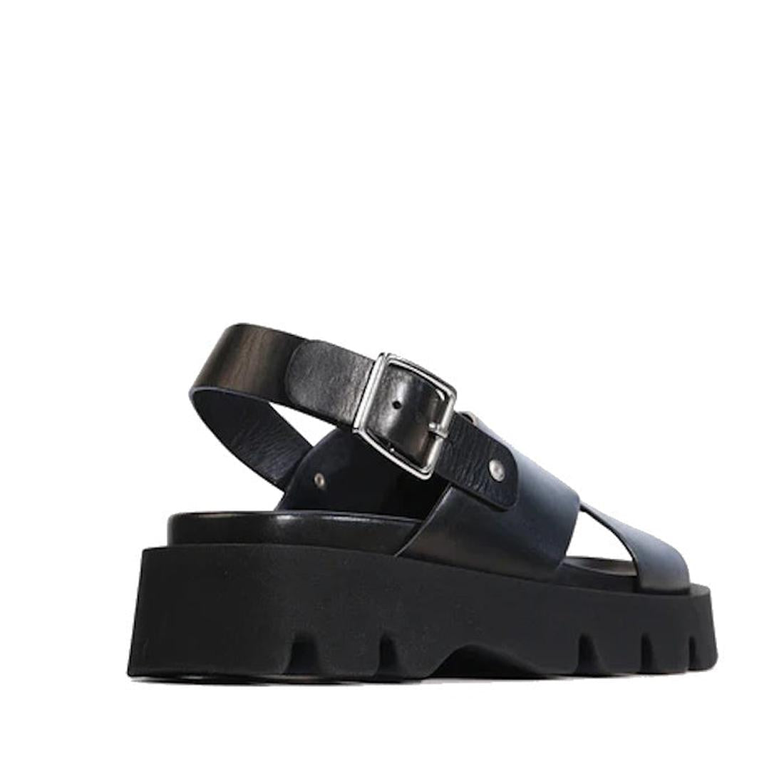 The EOS Monnis Black Womens Leather Sandal features a thick ridged platform sole, wide black leather straps, and a silver buckle, shown from a low rear angle against a white background., 48698, 48699, 9321191312279, 9321191312286, 9321191312293, 48703, 48