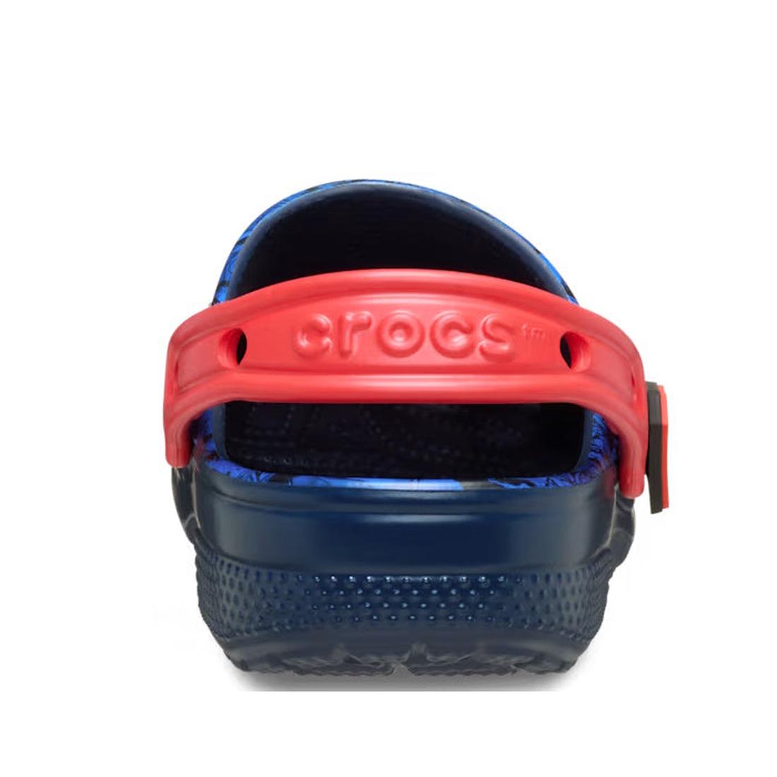 A close-up rear view of the Crocs Kids - Superman Classic Clog Blue - Junior Youths Sizes shows a blue clog with a red heel strap and the Crocs logo embossed on the strap., 198445182211, 198445182228, 198445182235, 198445182242, 198445182259, 198445182266