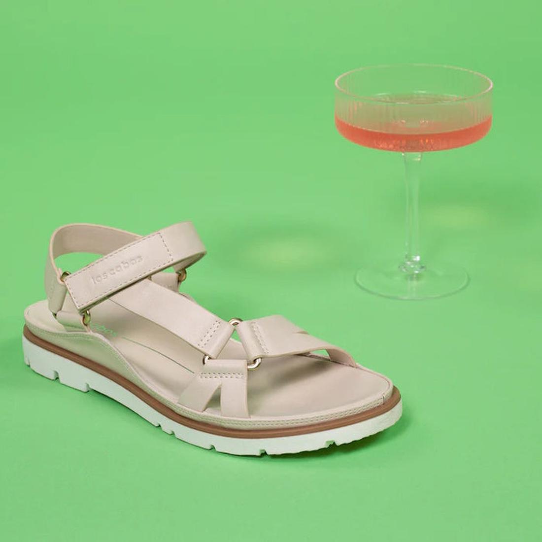 The Los Cabos Ashanti Bone Women's Sandal offers comfy beige vegan leather straps, a snug back strap, white sole, and soft footbed.  ksnz