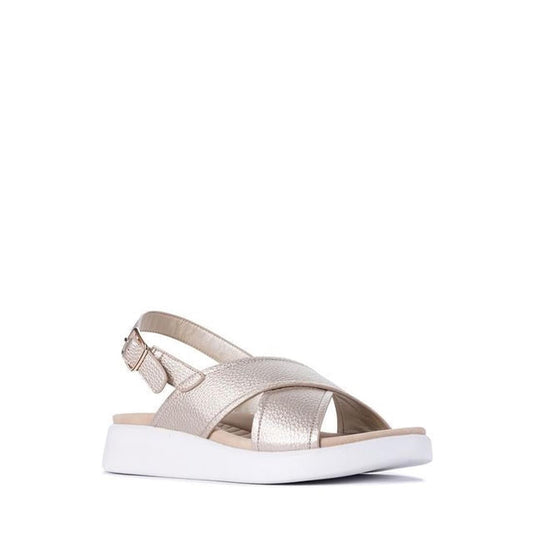 The Los Cabos Bogota Gold Womens Summer Sandal features vegan leather crisscross straps, an open toe, adjustable back strap, and a thick white sole—combining comfort and style in metallic gold.