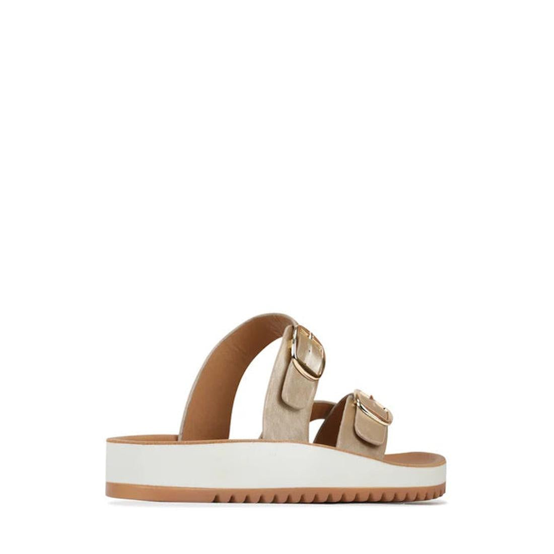 The Los Cabos Nins Champagne Adjustable Womens Summer Sandal features vegan leather in beige, two wide gold-buckle straps, and a thick white sole with a brown bottom and ridged tread for summer style., 46984, 9321191226729, 9321191226736, 9321191226743, 9
